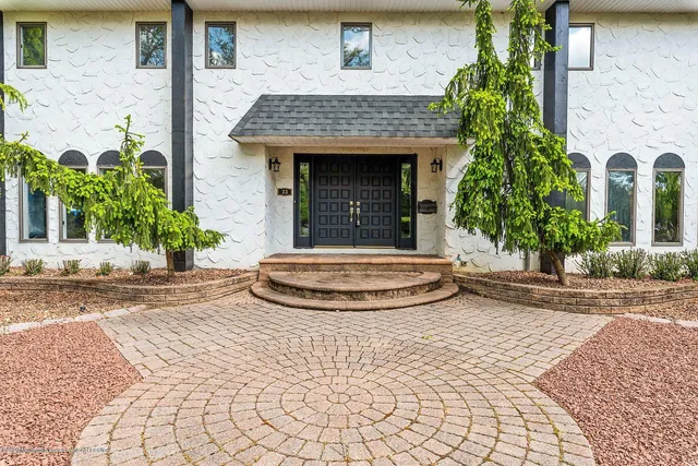 a view of a brick house with potted plants