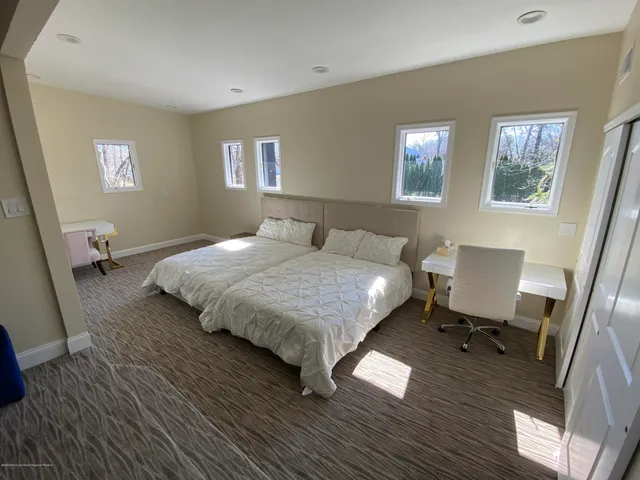 a bedroom with two beds and a window