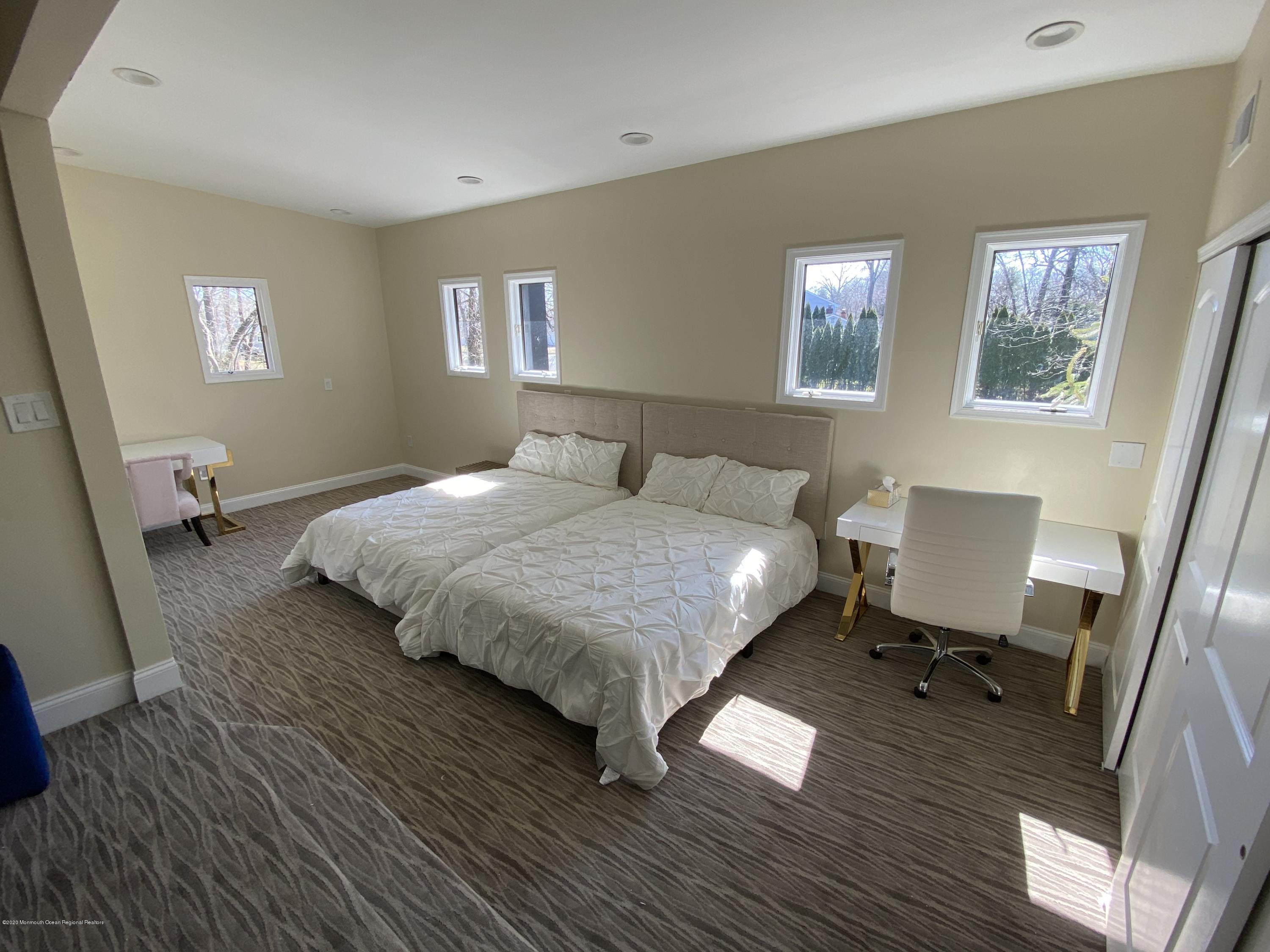 33 Heath Avenue Oakhurst, NJ 07755 - Photo 31 of 48 a bedroom with a bed and wooden floor