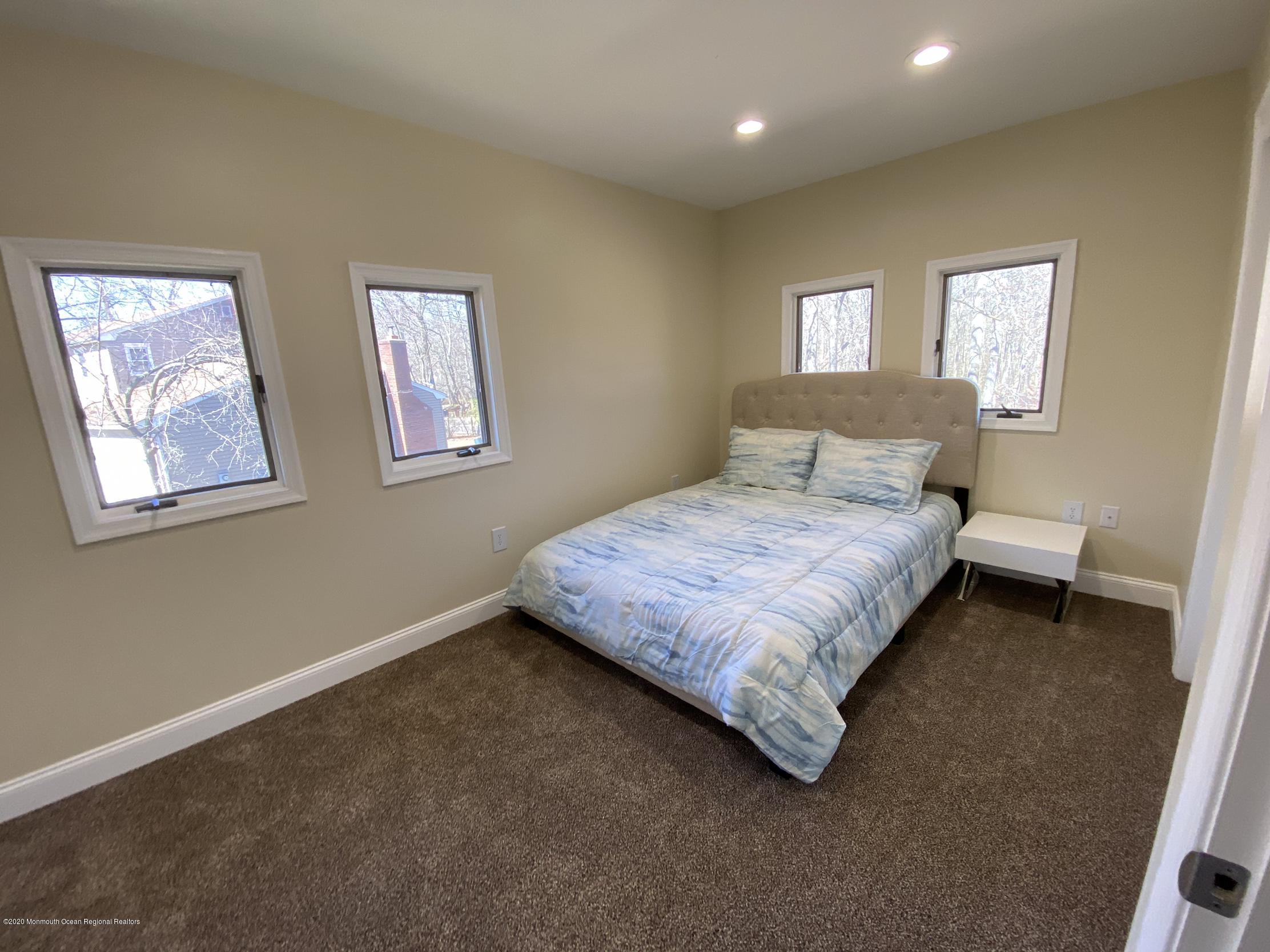 33 Heath Avenue Oakhurst, NJ 07755 - Photo 32 of 48 a bedroom with a bed and window