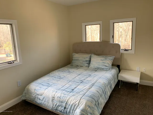 a bedroom with bed and window