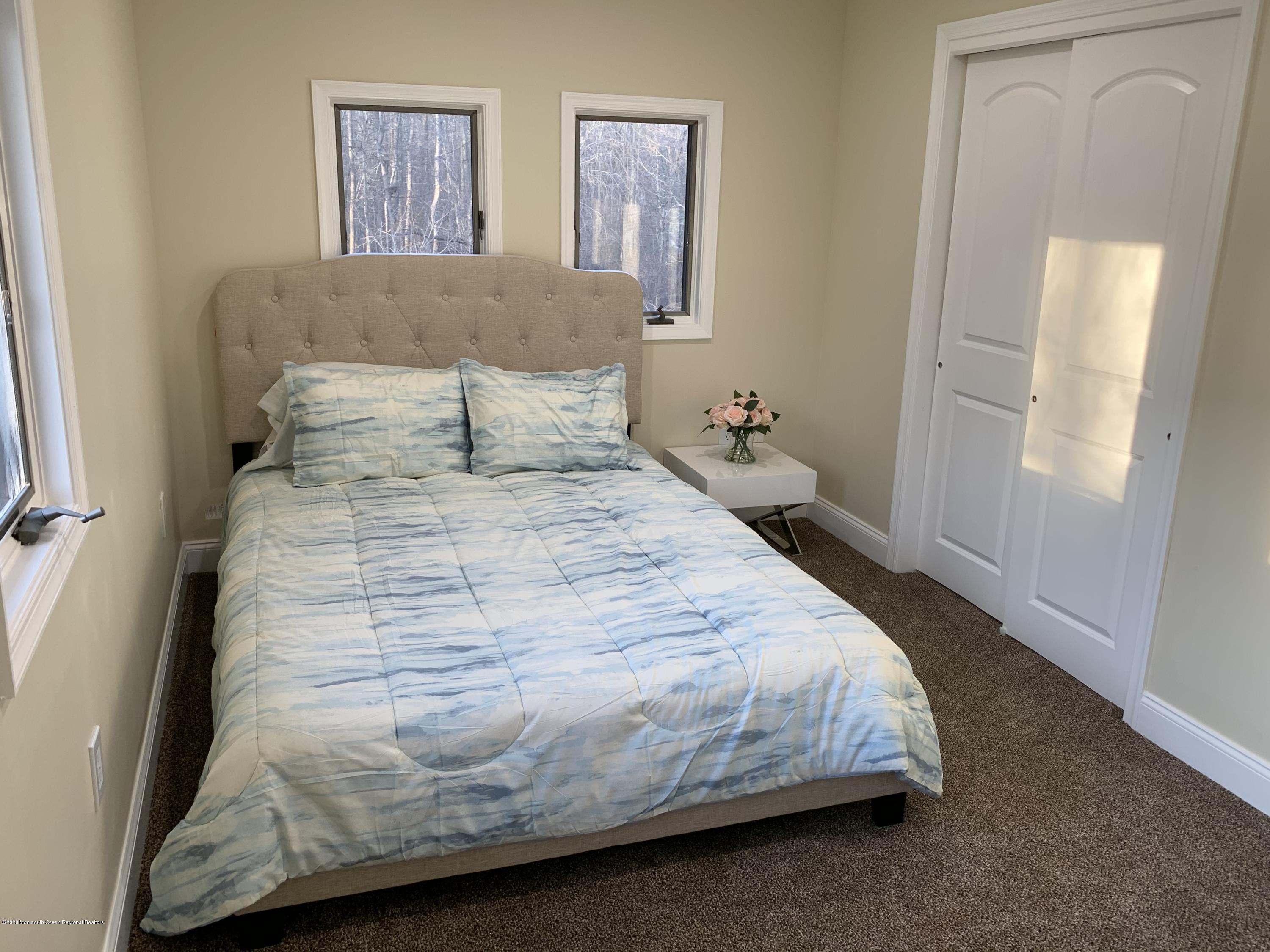 33 Heath Avenue Oakhurst, NJ 07755 - Photo 36 of 48 a bedroom with a bed and painting on the wall