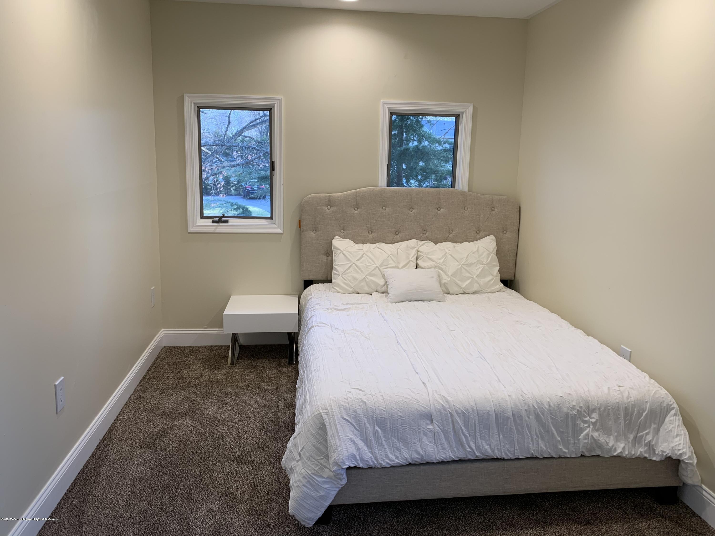 33 Heath Avenue Oakhurst, NJ 07755 - Photo 37 of 48 a bedroom with a bed and a painting on the wall