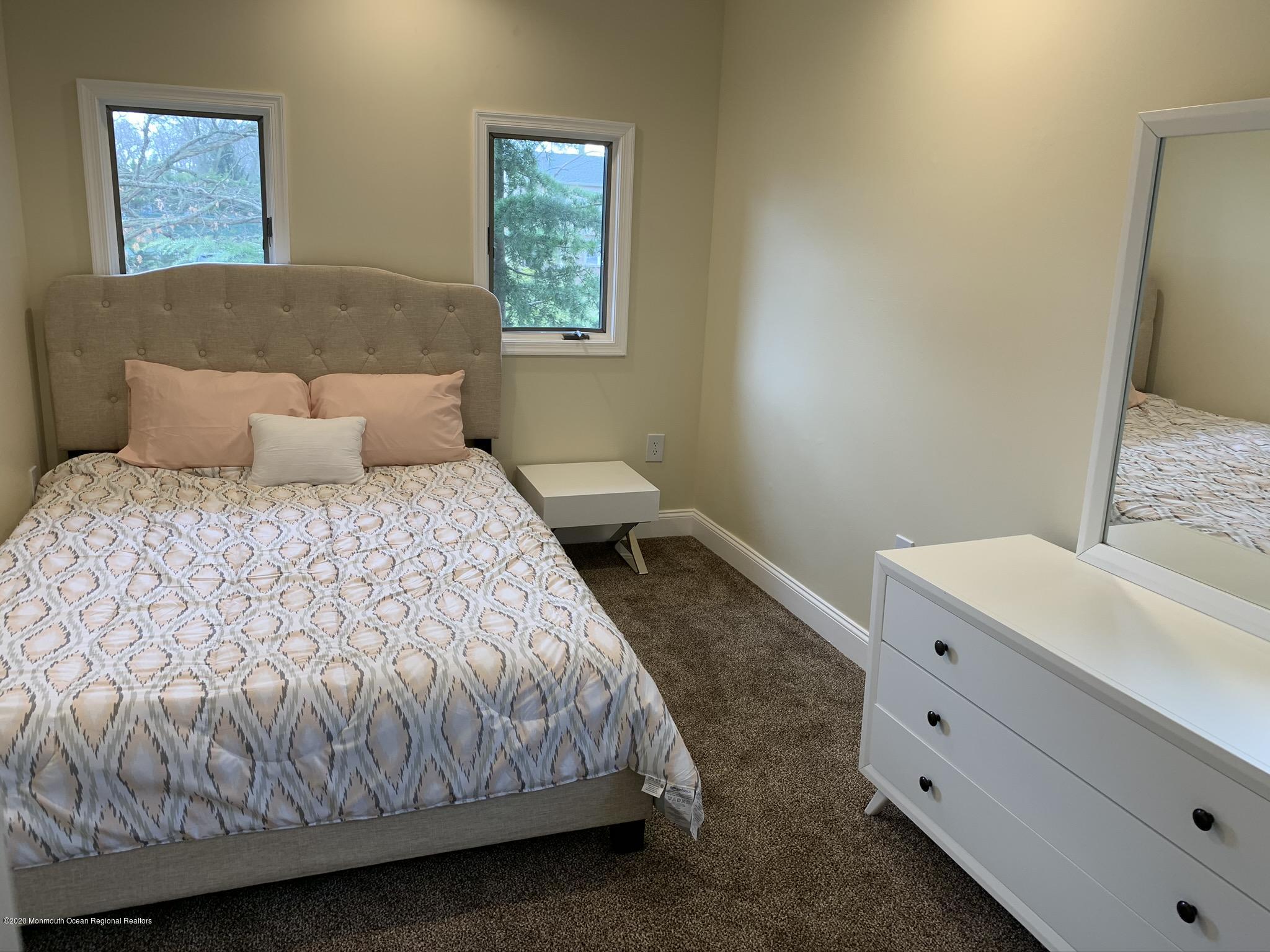 33 Heath Avenue Oakhurst, NJ 07755 - Photo 39 of 48 a bedroom with a bed and a window