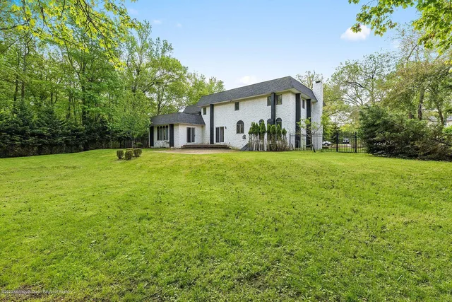 a front view of house with yard and trees