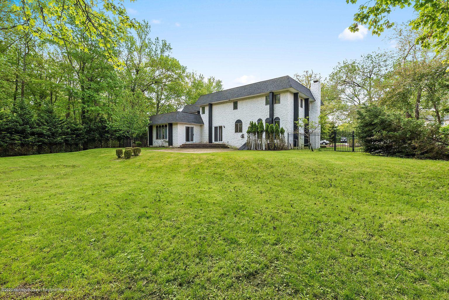 33 Heath Avenue Oakhurst, NJ 07755 - Photo 42 of 48 a front view of a house with a yard and trees