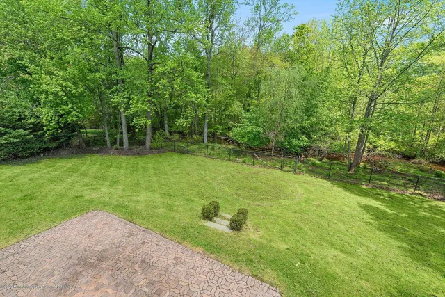 a view of green field with trees in the background