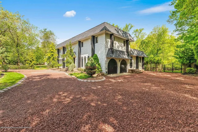 a view of a house with a yard and pathway