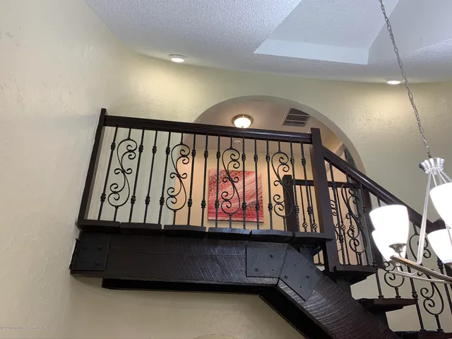 a large kitchen with stainless steel appliances kitchen island granite countertop a refrigerator and a stove top oven