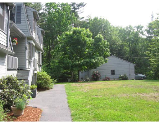 292 Mulpus Road Lunenburg, MA 01462 - Photo 15 of 18 a house with trees in front of it