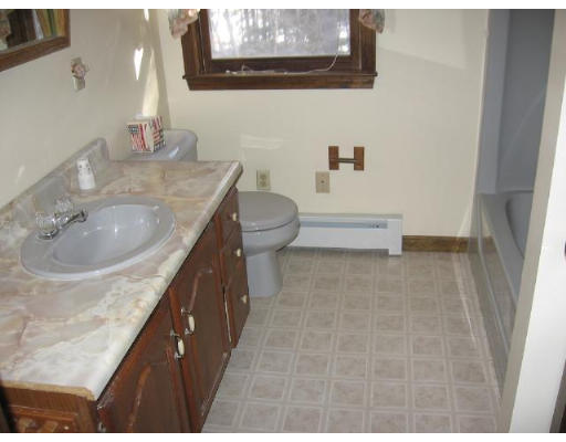 292 Mulpus Road Lunenburg, MA 01462 - Photo 8 of 18 a bathroom with a granite countertop sink a toilet and bathtub