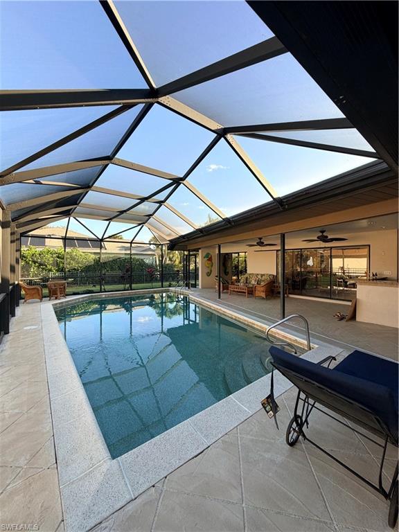 1941 Princess Court Naples, FL 34110 - Photo 2 of 17 a view of a patio with table and chairs under an umbrella