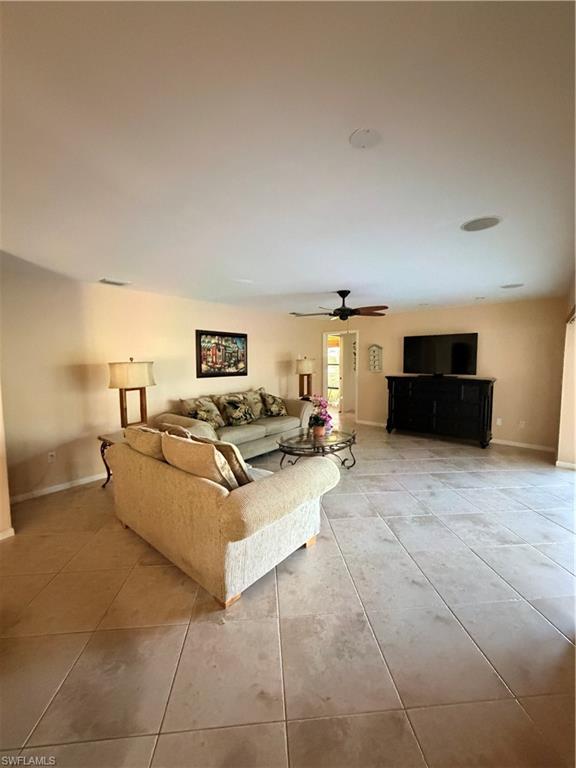 1941 Princess Court Naples, FL 34110 - Photo 9 of 17 a living room with furniture and a flat screen tv