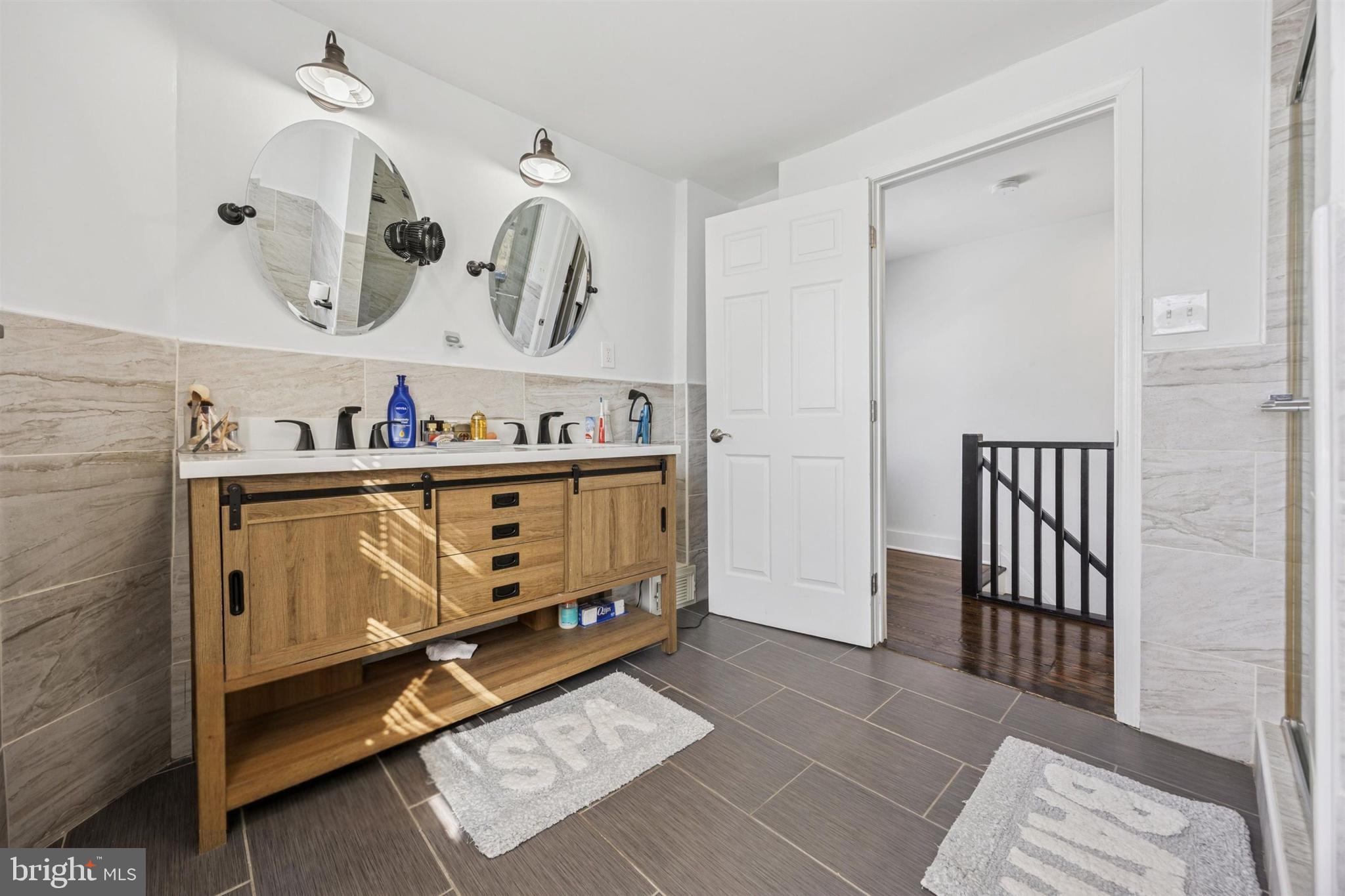 14 Maple Street Conshohocken, PA 19428 - Photo 25 of 27 a bathroom with a sink mirror and vanity