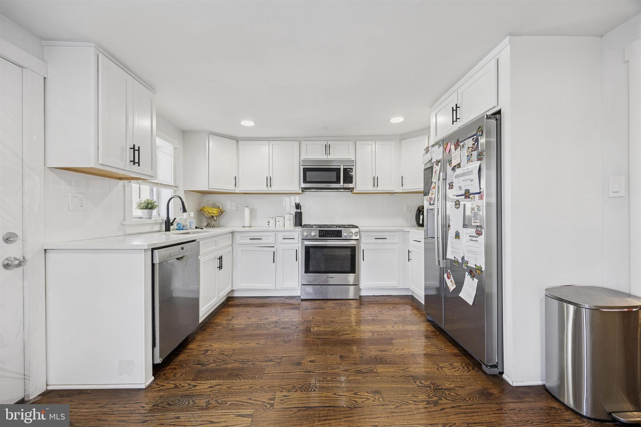 14 Maple Street Conshohocken, PA 19428 - Photo 8 of 27 a kitchen with white cabinets and stainless steel appliances