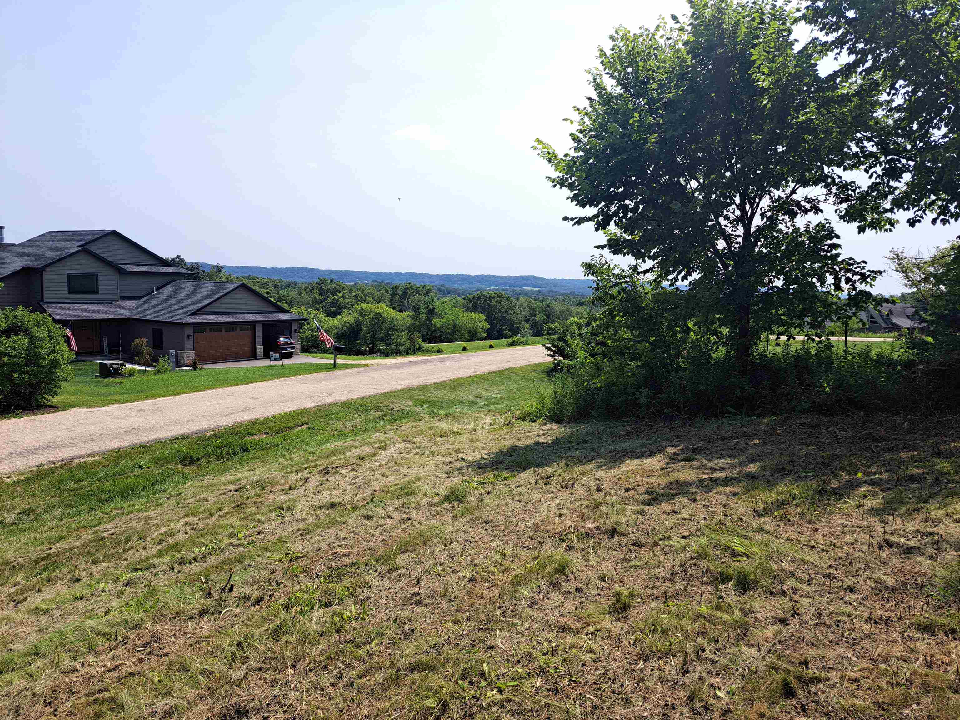12 Saddleback Road Galena, IL 61036 - Photo 9 of 14 a view of patio with a table and chairs under an umbrella