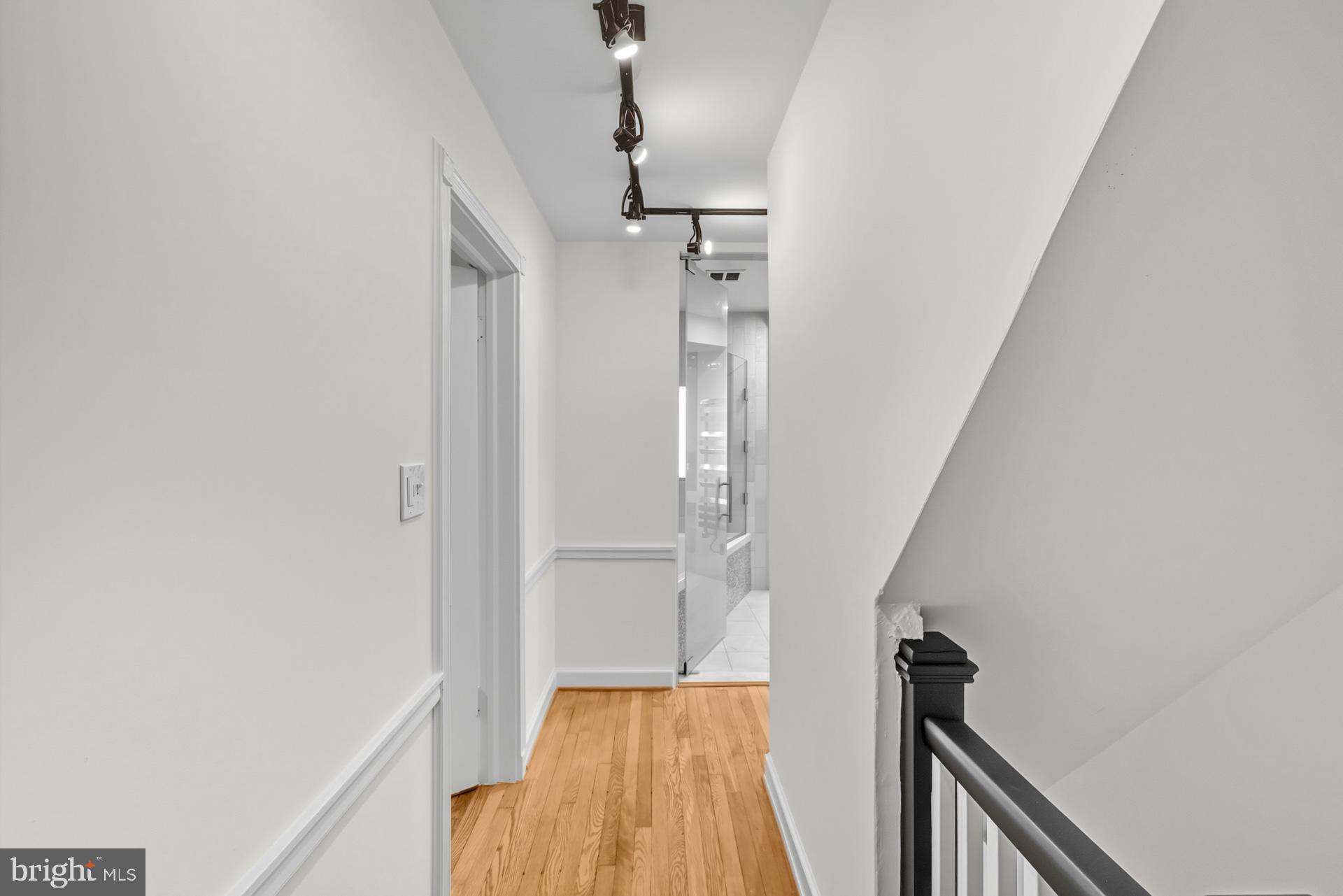 1628 44th Street Northwest Washington, DC 20007 - Photo 15 of 40 a view of hallway with stairs and wooden floor