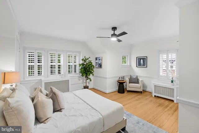 a bedroom with a bed couch and a window