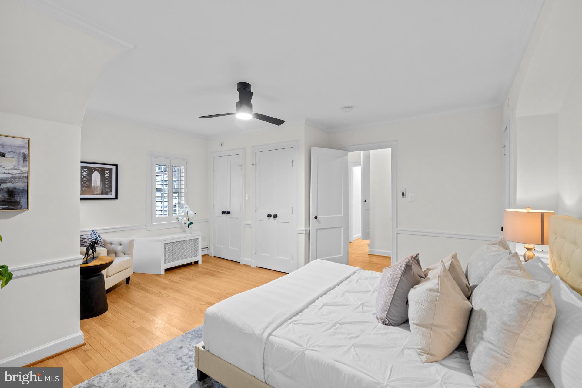 1628 44th Street Northwest Washington, DC 20007 - Photo 17 of 40 a bedroom with a bed and a chandelier