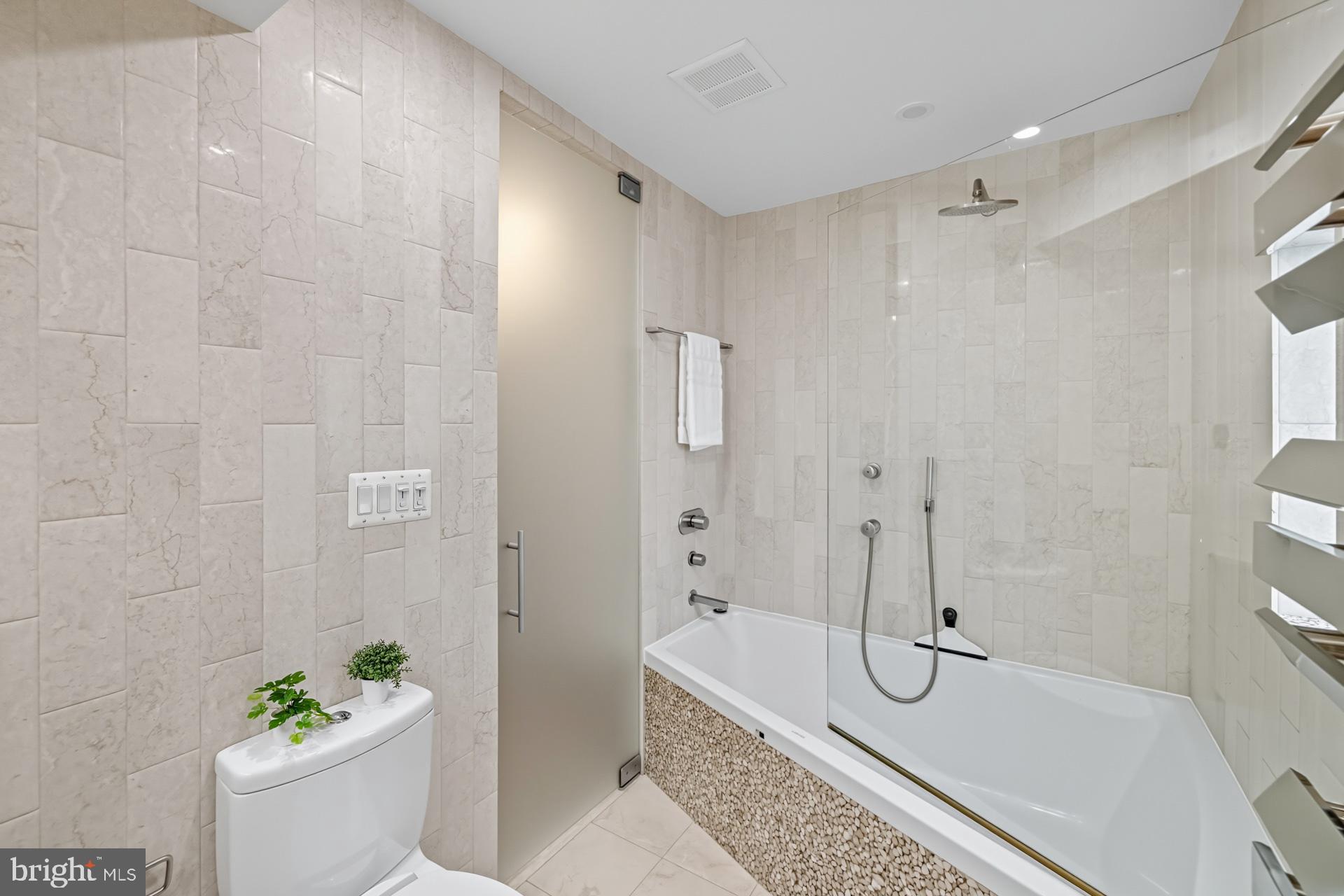 1628 44th Street Northwest Washington, DC 20007 - Photo 20 of 40 a bathroom with a granite countertop sink a toilet and shower