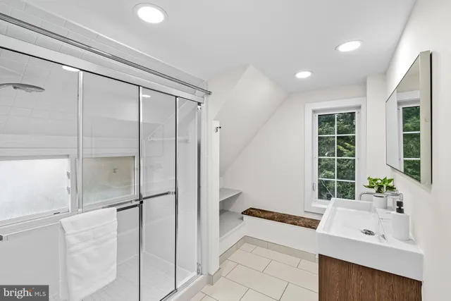 a spacious bathroom with a tub and a sink