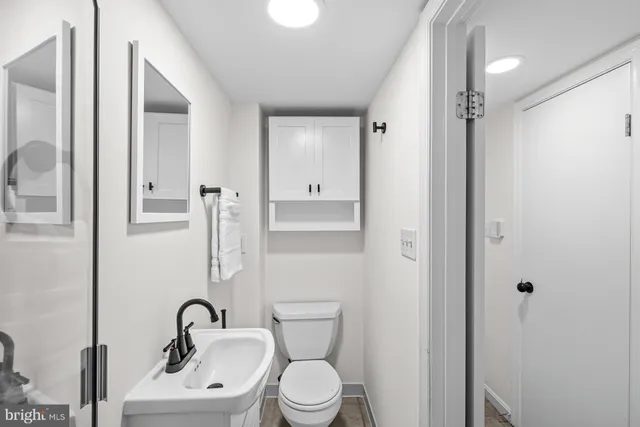 a bathroom with a toilet sink and shower