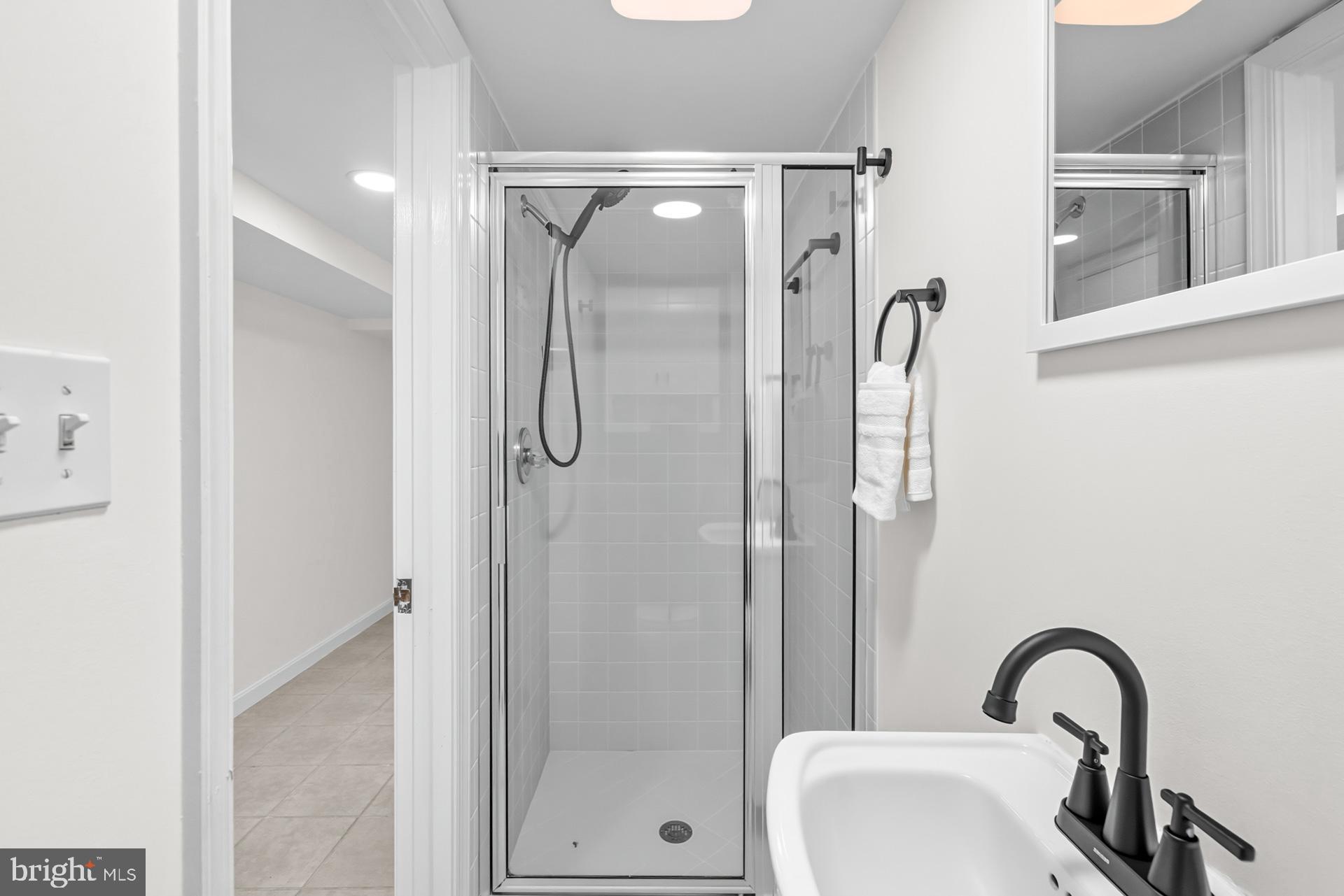 1628 44th Street Northwest Washington, DC 20007 - Photo 29 of 40 a bathroom with a shower sink and mirror