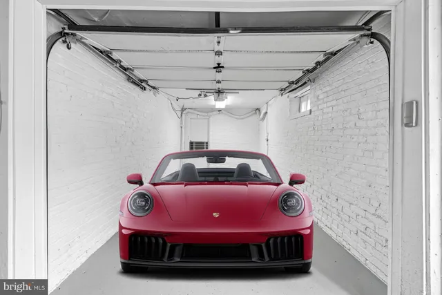 a view of a hallway with a ceiling fan and window