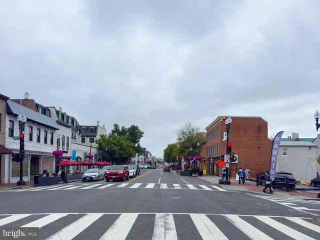 a view of a lake with a bench and trees