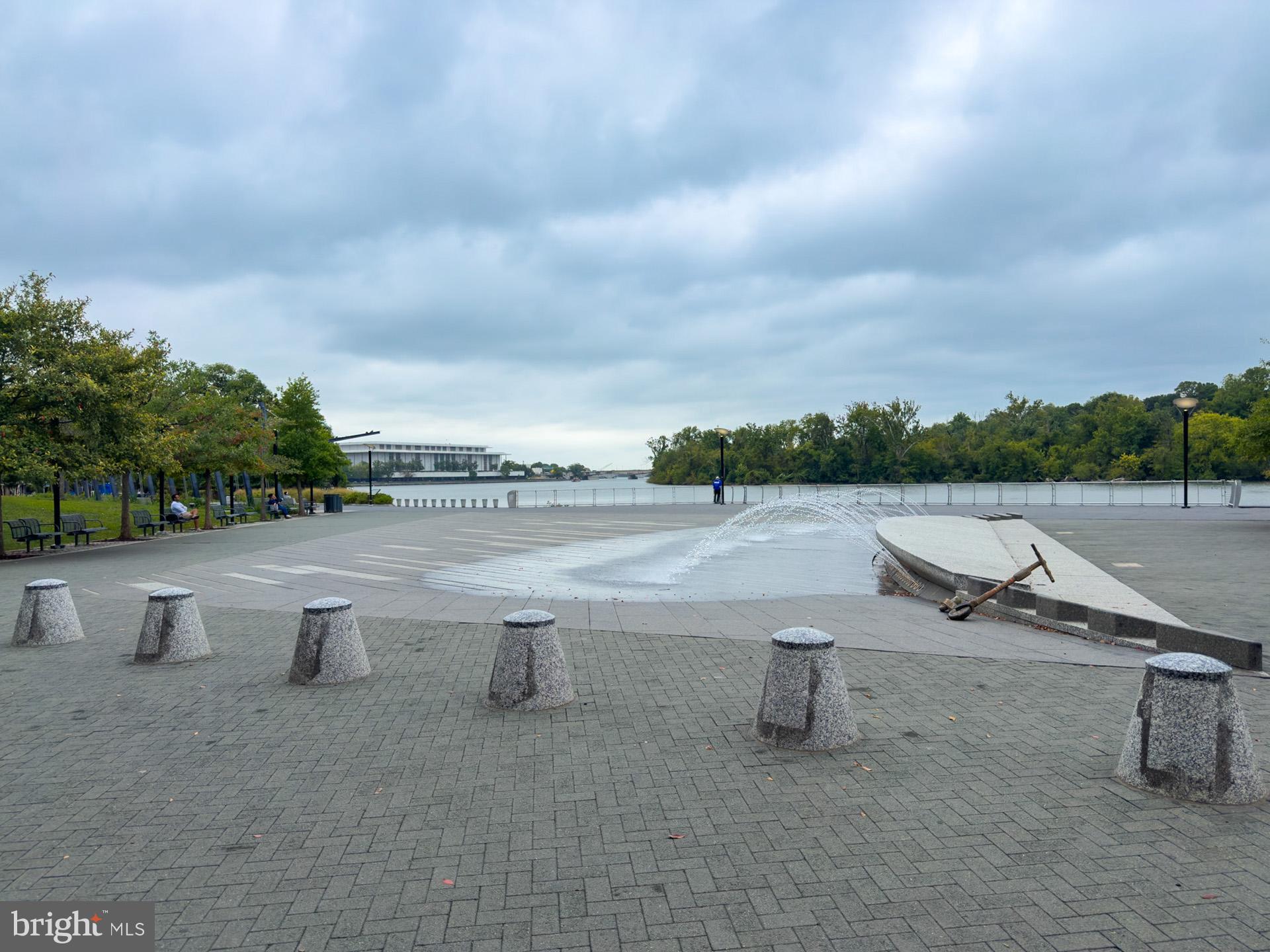1628 44th Street Northwest Washington, DC 20007 - Photo 38 of 40 a view of a lake with a bench and trees