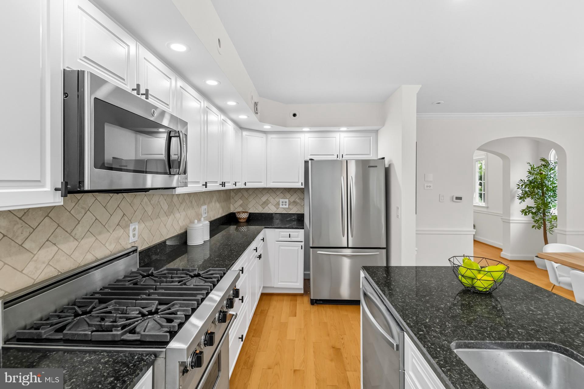 1628 44th Street Northwest Washington, DC 20007 - Photo 9 of 40 a kitchen with granite countertop a stove sink and refrigerator