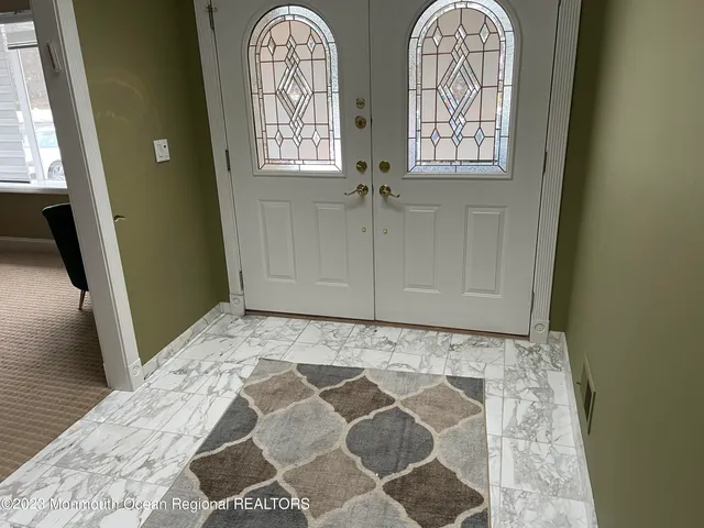 a view of front door with wooden floor
