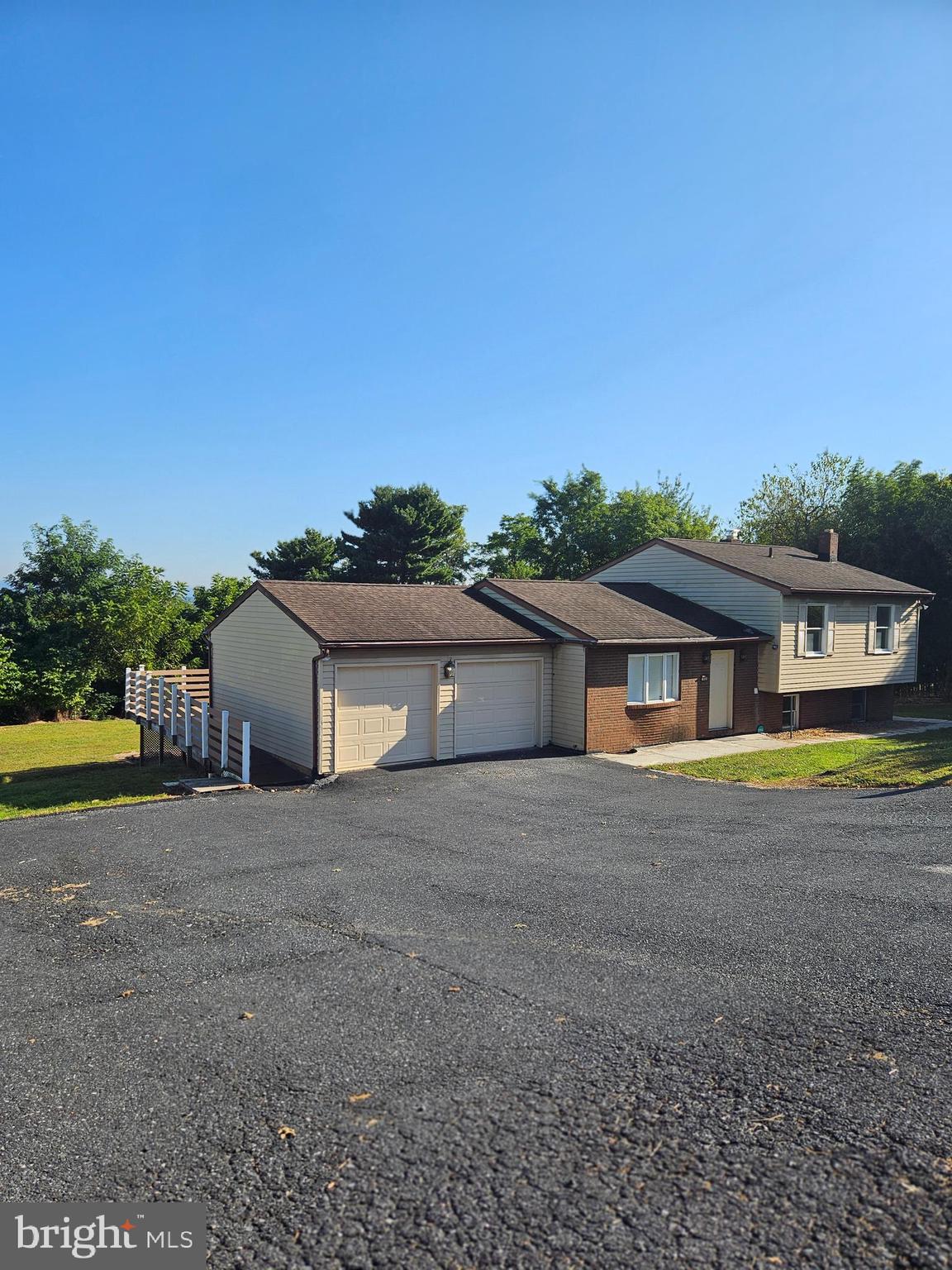 7860 Chambers Hill Road Harrisburg, PA 17111 - Photo 13 of 16 a front view of a house with a yard and garage