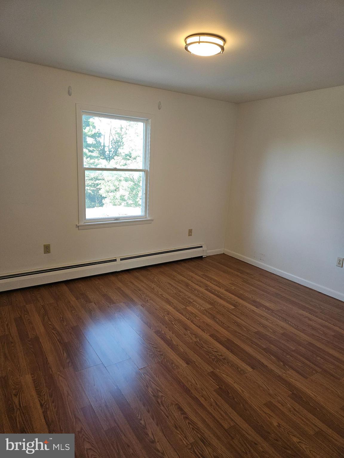 7860 Chambers Hill Road Harrisburg, PA 17111 - Photo 6 of 16 an empty room with wooden floor and windows