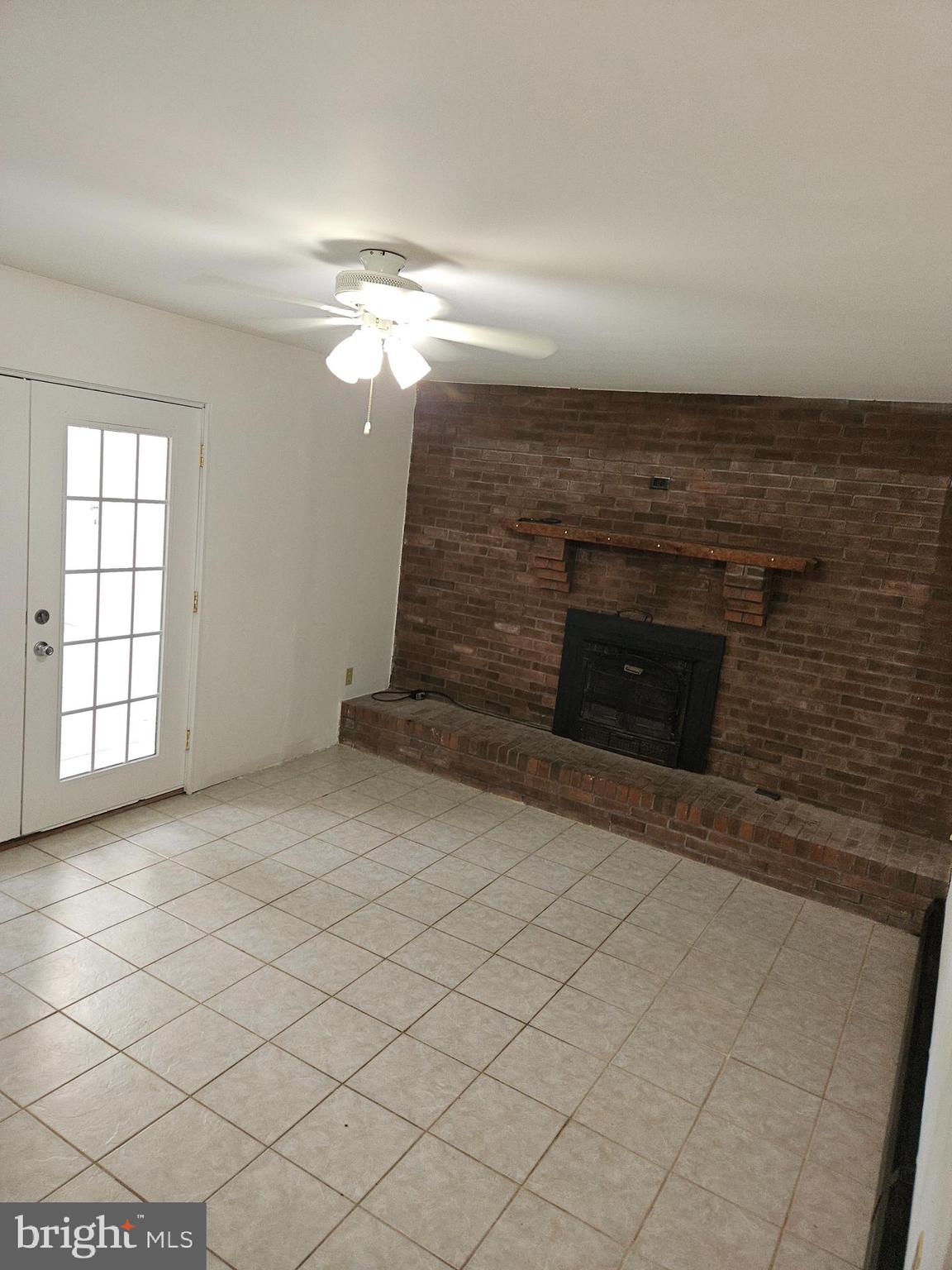 7860 Chambers Hill Road Harrisburg, PA 17111 - Photo 7 of 16 wooden floor in an empty room with a fireplace