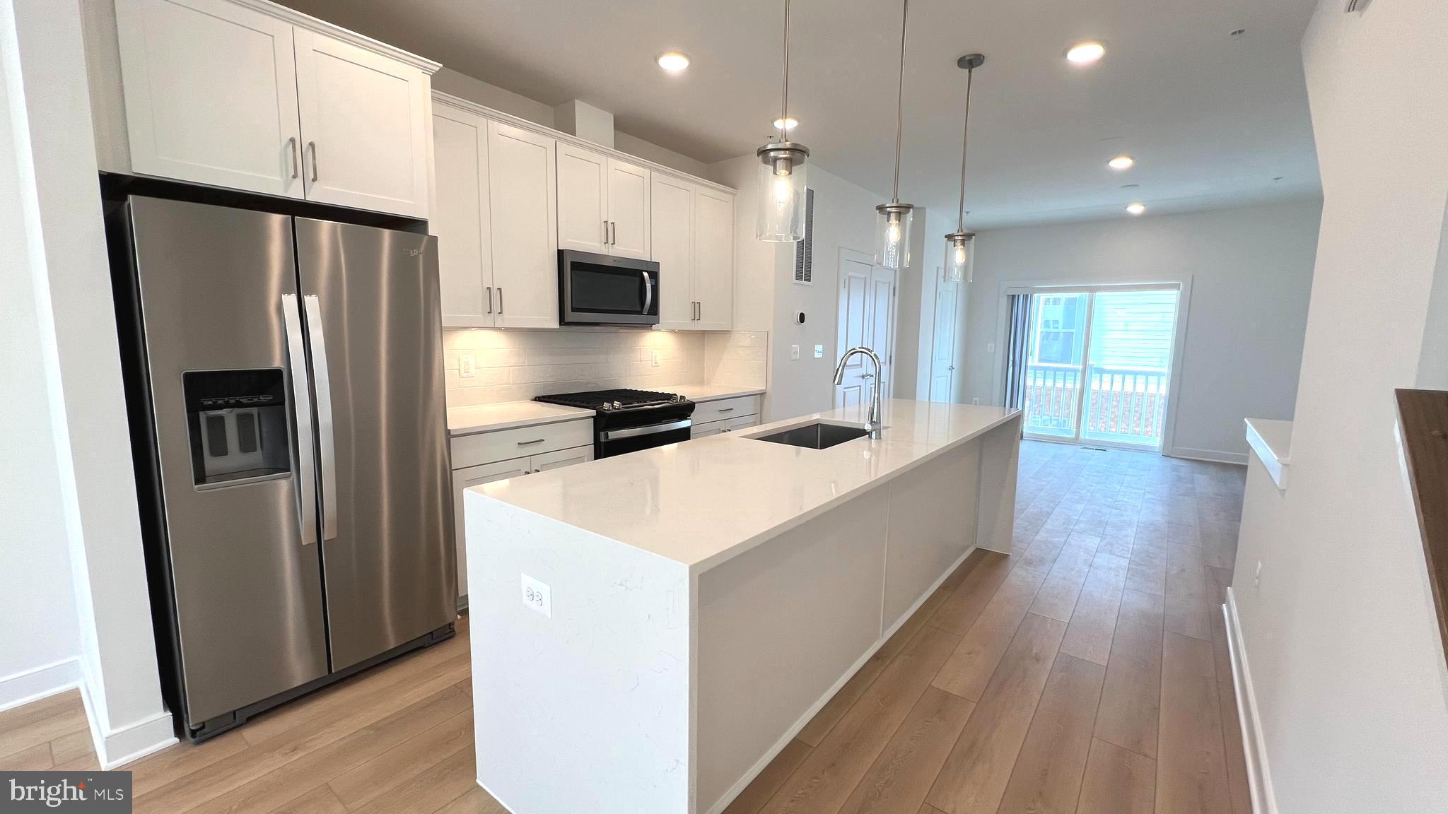 3122 Nina Clarke Drive Gaithersburg, MD 20877 - Photo 13 of 22 a large kitchen with a refrigerator a sink and a stove top oven