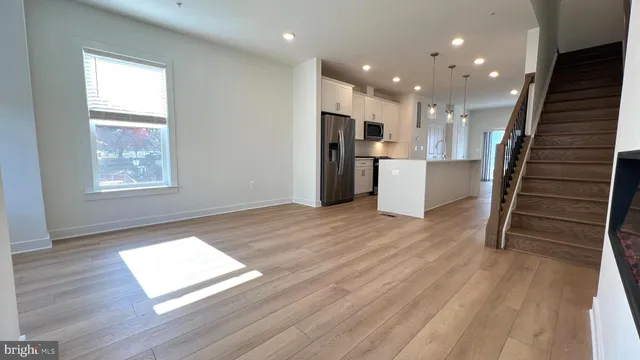 a view of a kitchen with furniture and wooden floor