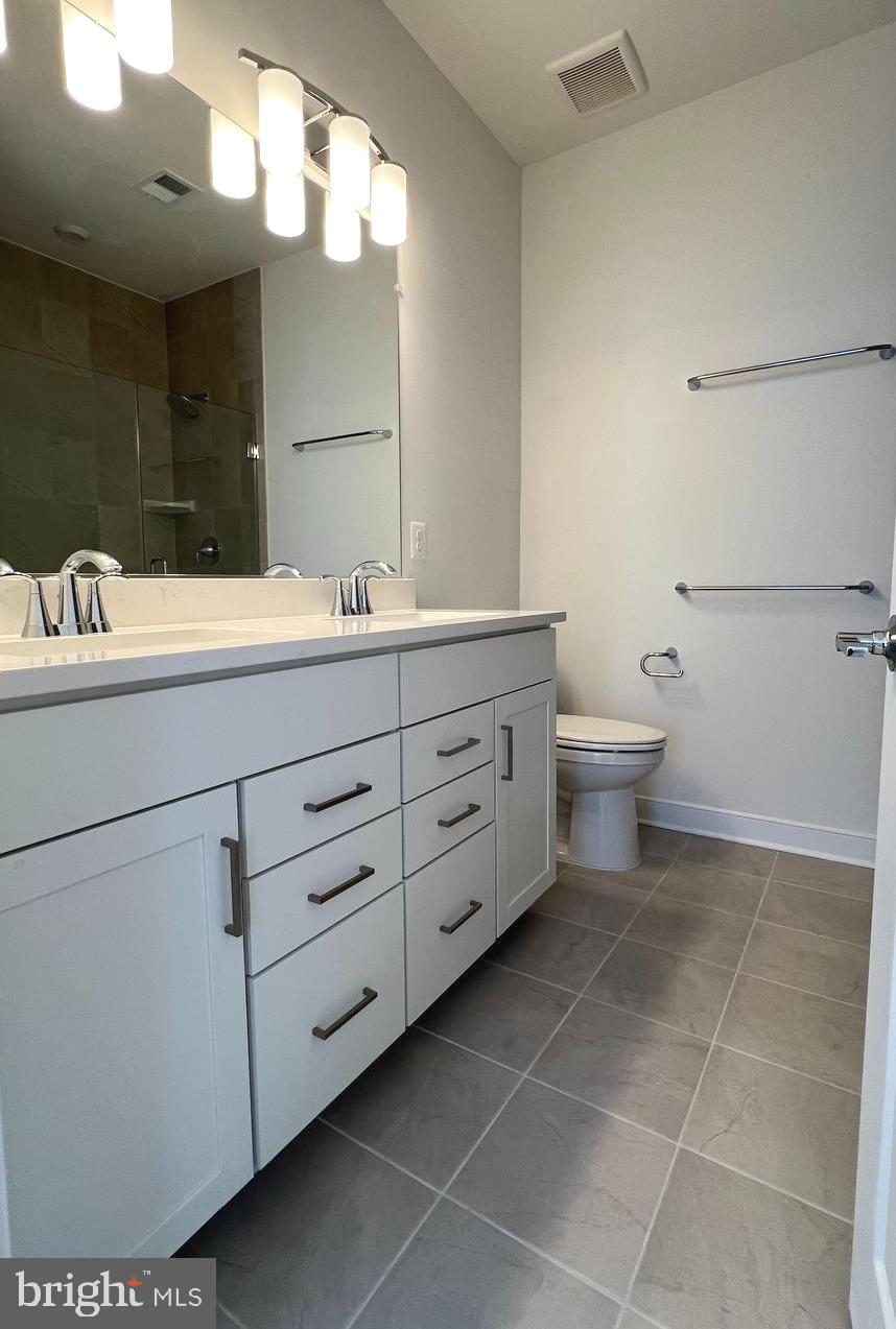 3122 Nina Clarke Drive Gaithersburg, MD 20877 - Photo 16 of 22 a bathroom with a sink a mirror and a toilet