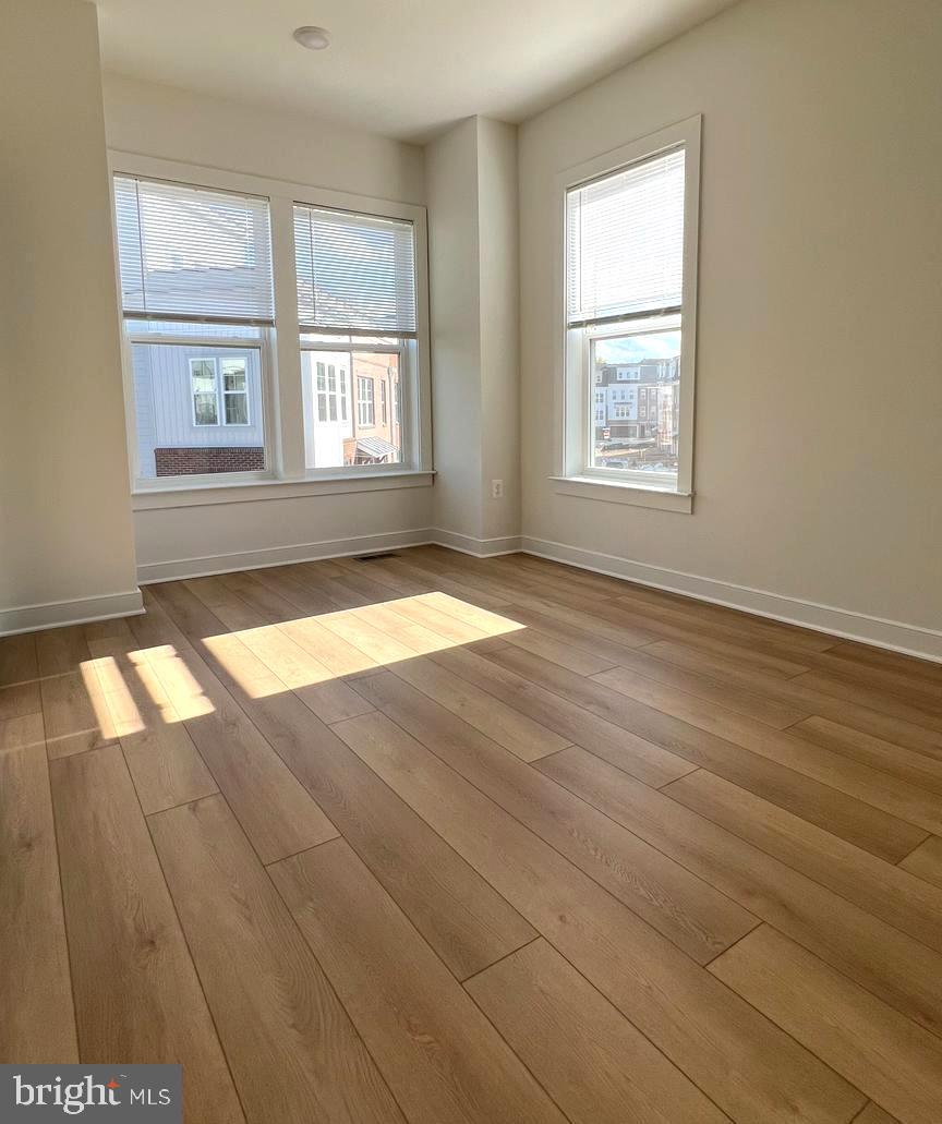 3122 Nina Clarke Drive Gaithersburg, MD 20877 - Photo 19 of 22 an empty room with wooden floor and windows