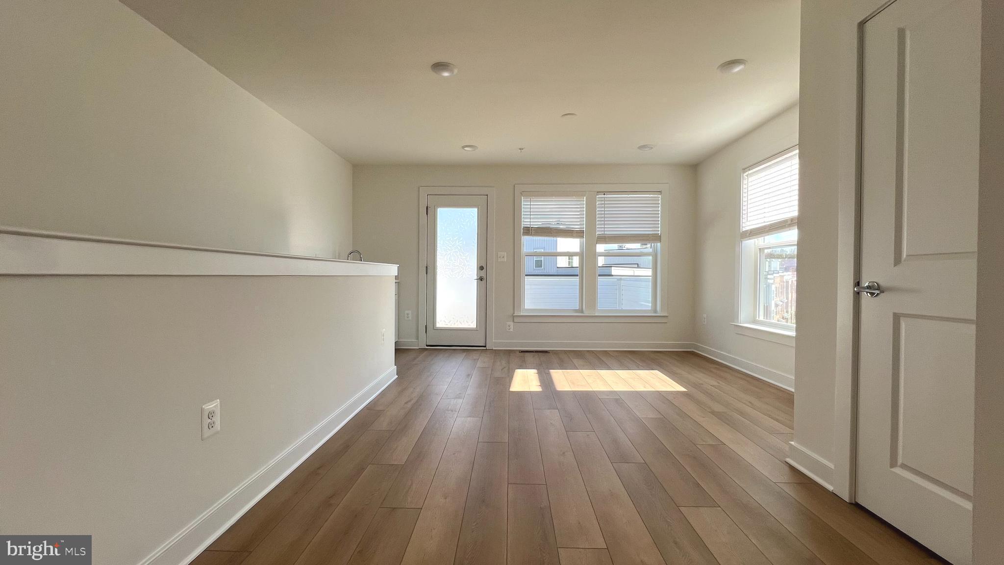3122 Nina Clarke Drive Gaithersburg, MD 20877 - Photo 21 of 22 a view of an empty room with wooden floor and a window