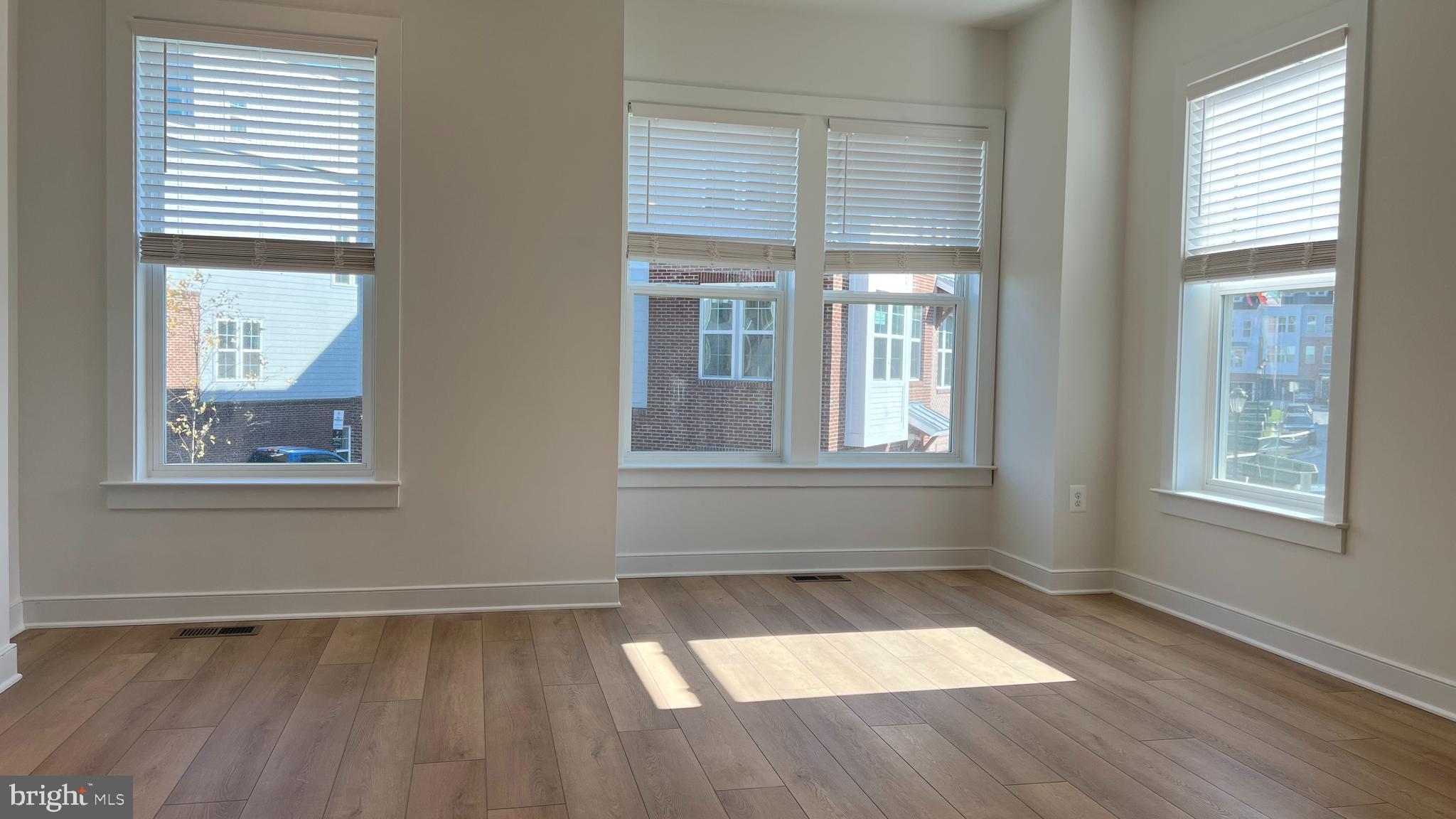 3122 Nina Clarke Drive Gaithersburg, MD 20877 - Photo 6 of 22 an empty room with wooden floor and windows