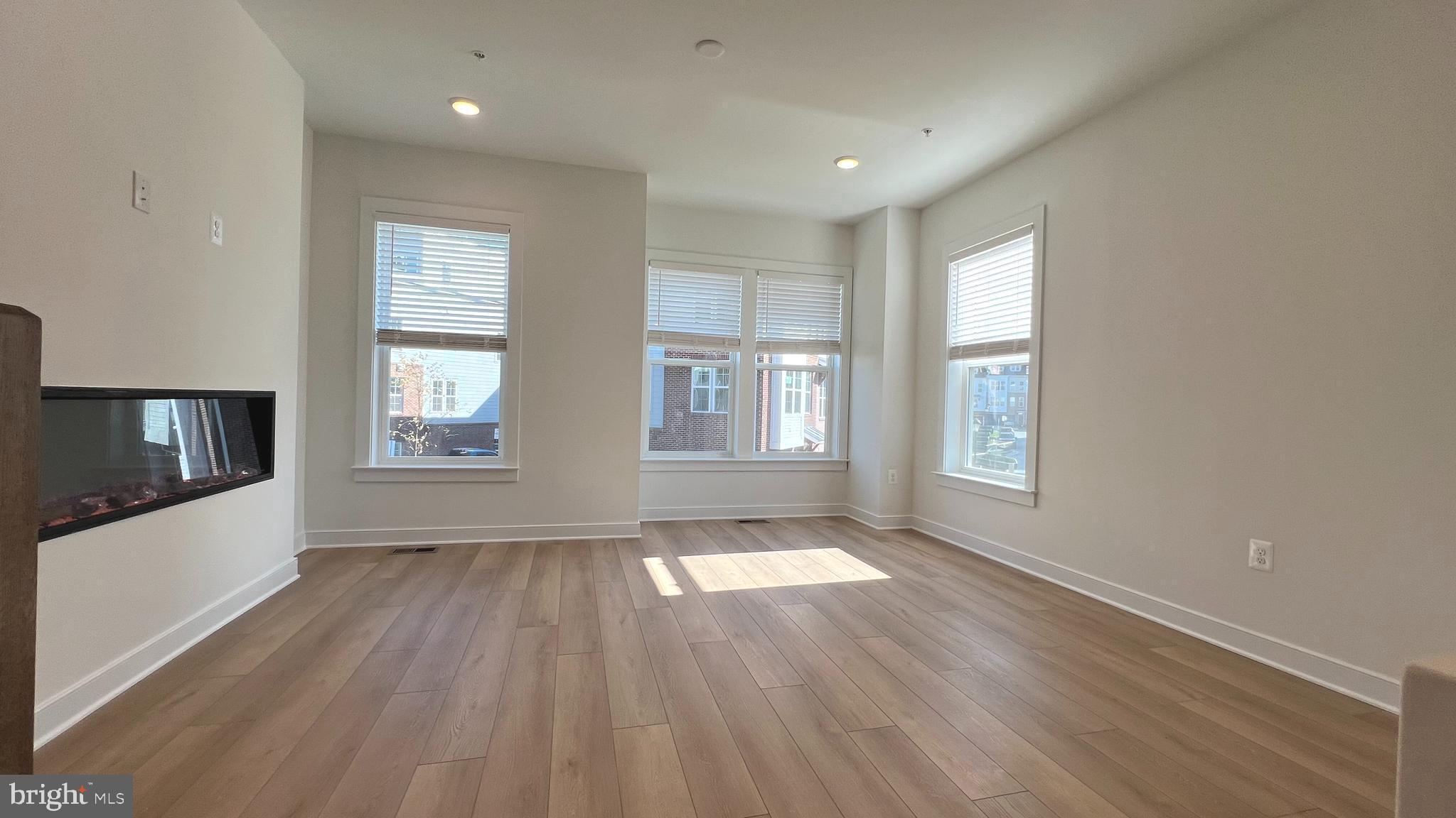 3122 Nina Clarke Drive Gaithersburg, MD 20877 - Photo 7 of 22 a view of an empty room with wooden floor and a window