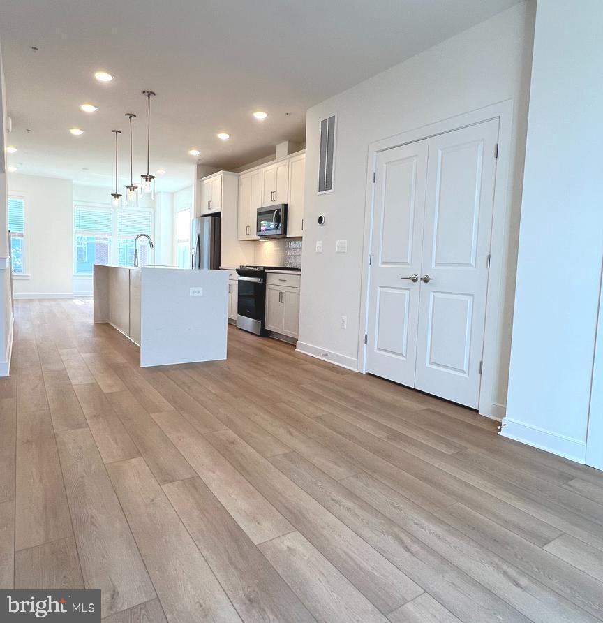 3122 Nina Clarke Drive Gaithersburg, MD 20877 - Photo 8 of 22 a view of kitchen with kitchen island sink and center island