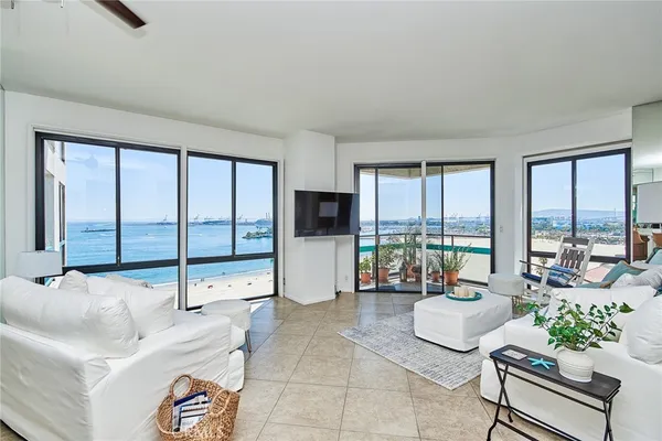 a living room with furniture and large windows