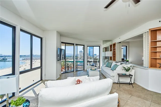 a living room with furniture and large windows