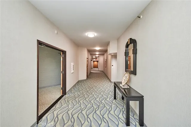 a view of a hallway with closet and wooden floor