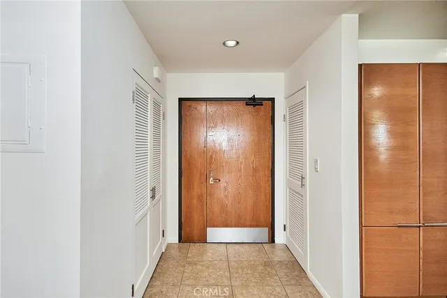 a view of a hallway with wooden shelves