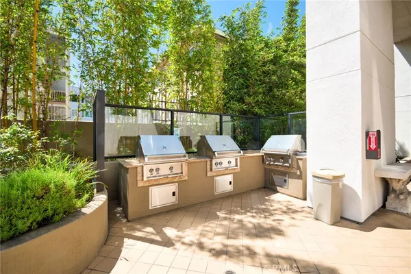 a view of a patio with table and chairs and potted plants