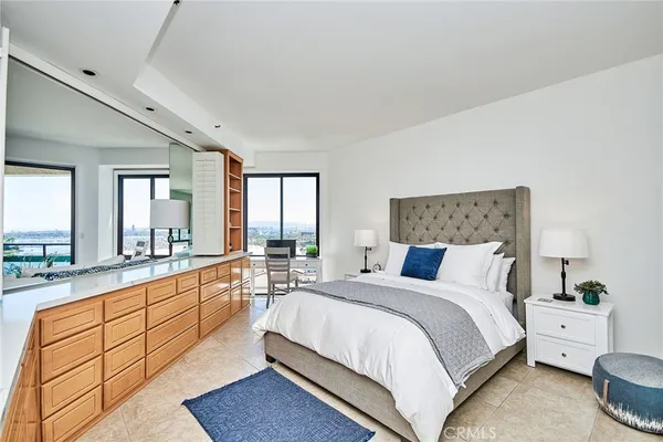 a large bedroom with a large bed and a large window
