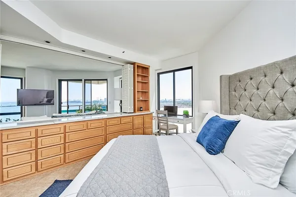 a bedroom with a large bed and a large window